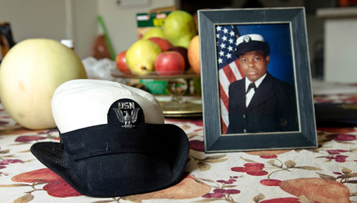 United Way veteran beneficiary Marva Lewis navy hat and service photograph